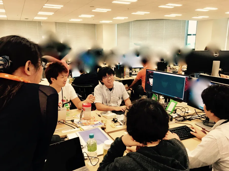 オフィスでチームが集まってモブプログラミングをしている様子